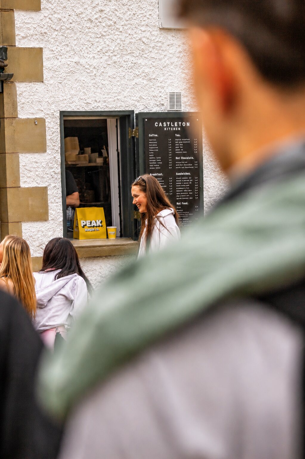 The Castleton Kitchen serving window with a Peak Burger Co bag